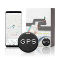 Mini GPS tracker black circular device with GPS text next to smartphone displaying map interface