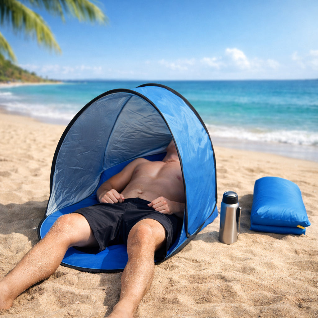 Orange pop-up beach tent with UV protection set up on sandy beach, showing full structure with carry bag alongside