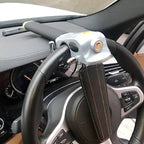 Triple locking steering wheel security device installed on car steering wheel silver metal