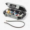 Portable grey ABS safe box open with combination lock showing phone watch sunglasses keys and cards inside
