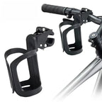 Black bike bottle cage with lever-lock clamp mount shown detached and mounted on bicycle handlebar, white background