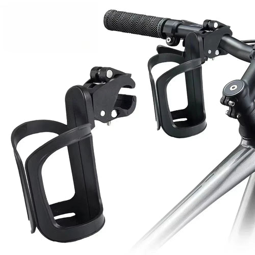 Black bike bottle cage with lever-lock clamp mount shown detached and mounted on bicycle handlebar, white background