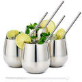Stainless steel tumblers 4-pack with straws lime mint cocktails white background