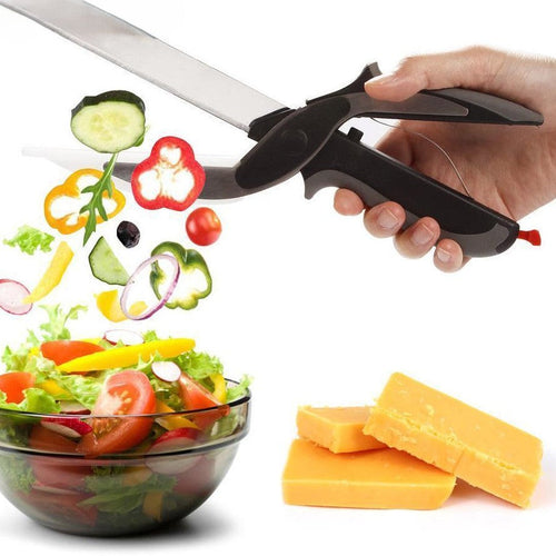 Kitchen scissors with integrated cutting board cutting vegetables over salad bowl