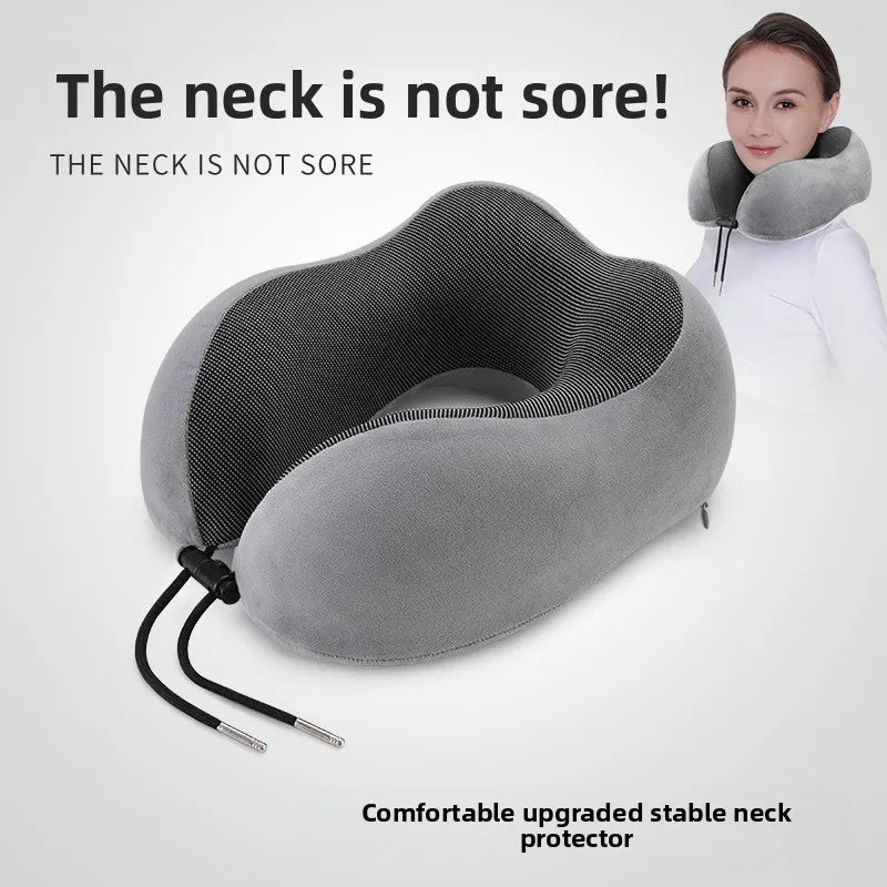 Grey U-shaped memory foam travel neck pillow on white background showing velvet outer and mesh inner panel