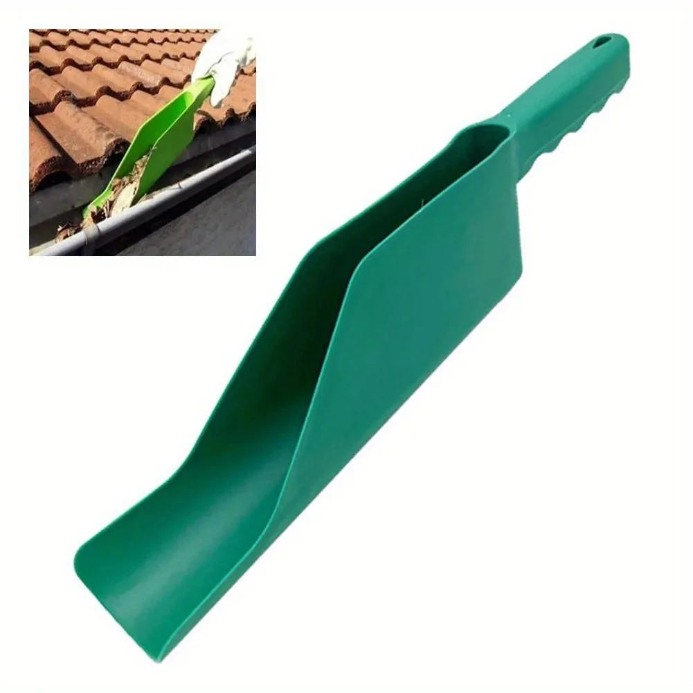 Green plastic gutter cleaning scoop used by gloved hand to remove wet leaves from a residential roof gutter