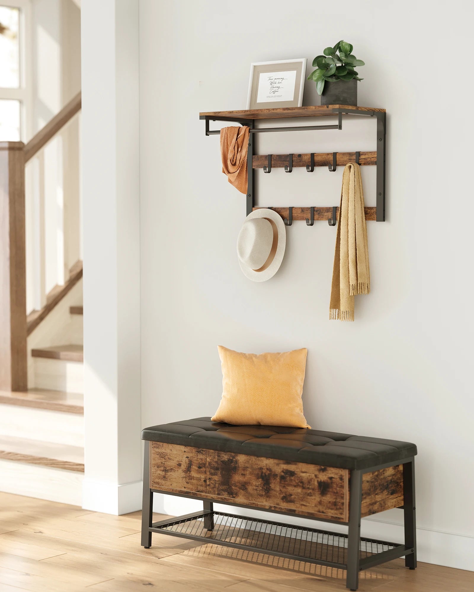 Wall-mounted coat rack with top shelf, hanging rod, and two rows of black hooks in rustic brown and black, styled in a bright hallway with coats and scarves