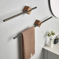 Walnut wood wall-mounted towel bar with matte black bar and diamond bracket, two bars on grey bathroom wall with linen towel hanging