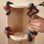 Orange black corner clamps securing wooden boards in perfect 90 degree angle woodworking assembly