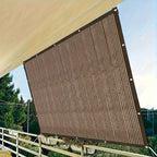 Brown PE shade sail stretched between mounting points on outdoor patio showing ribbed mesh texture