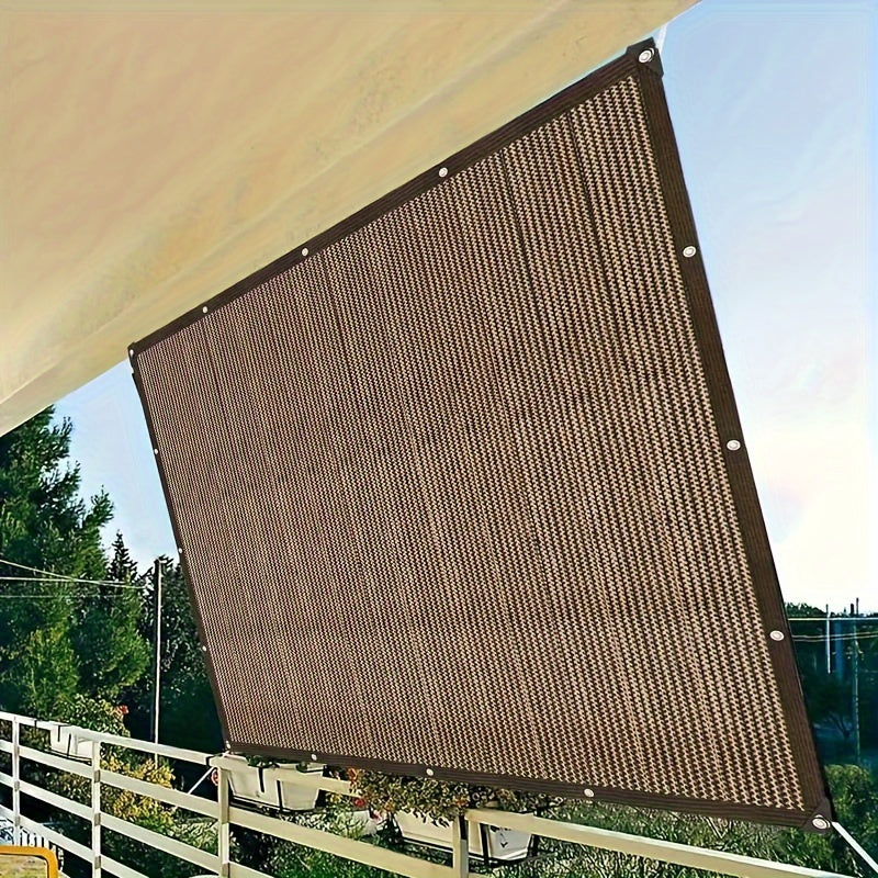 Brown PE shade sail stretched between mounting points on outdoor patio showing ribbed mesh texture