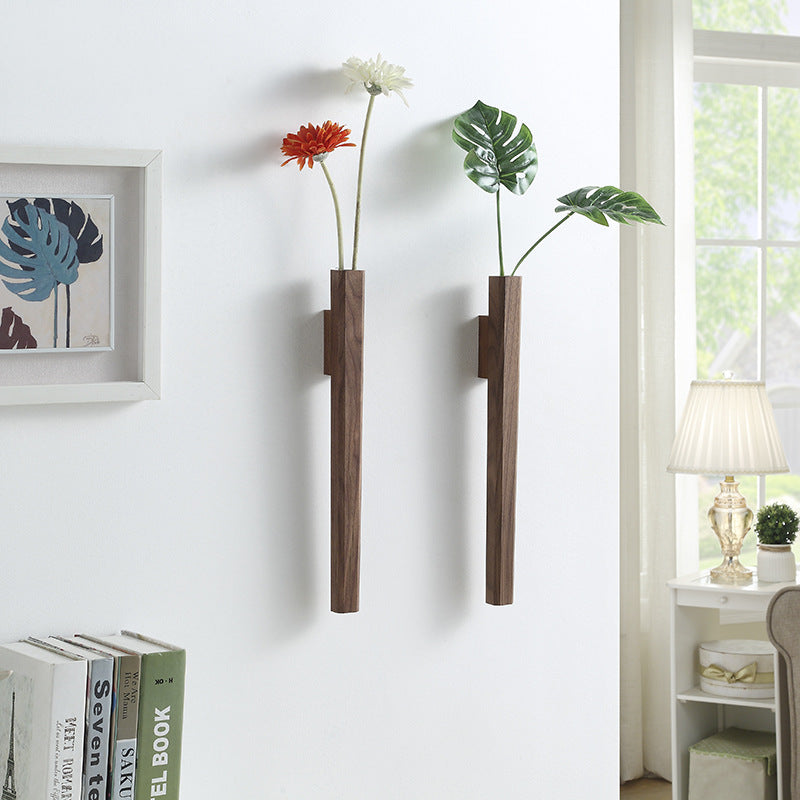Walnut and beech wood wall vases set of 2 mounted on white wall holding flowers in lounge room setting