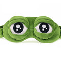 3D green plush frog eye sleep mask front view on white background showing embroidered eye detail and raised dome shape