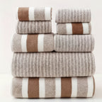 Six-piece striped microfibre towel set in coffee brown and white tones, folded and stacked on white background
