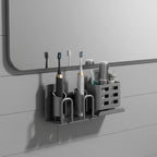 Wall-mounted aluminium toothbrush holder with electric toothbrushes and toiletries in modern bathroom