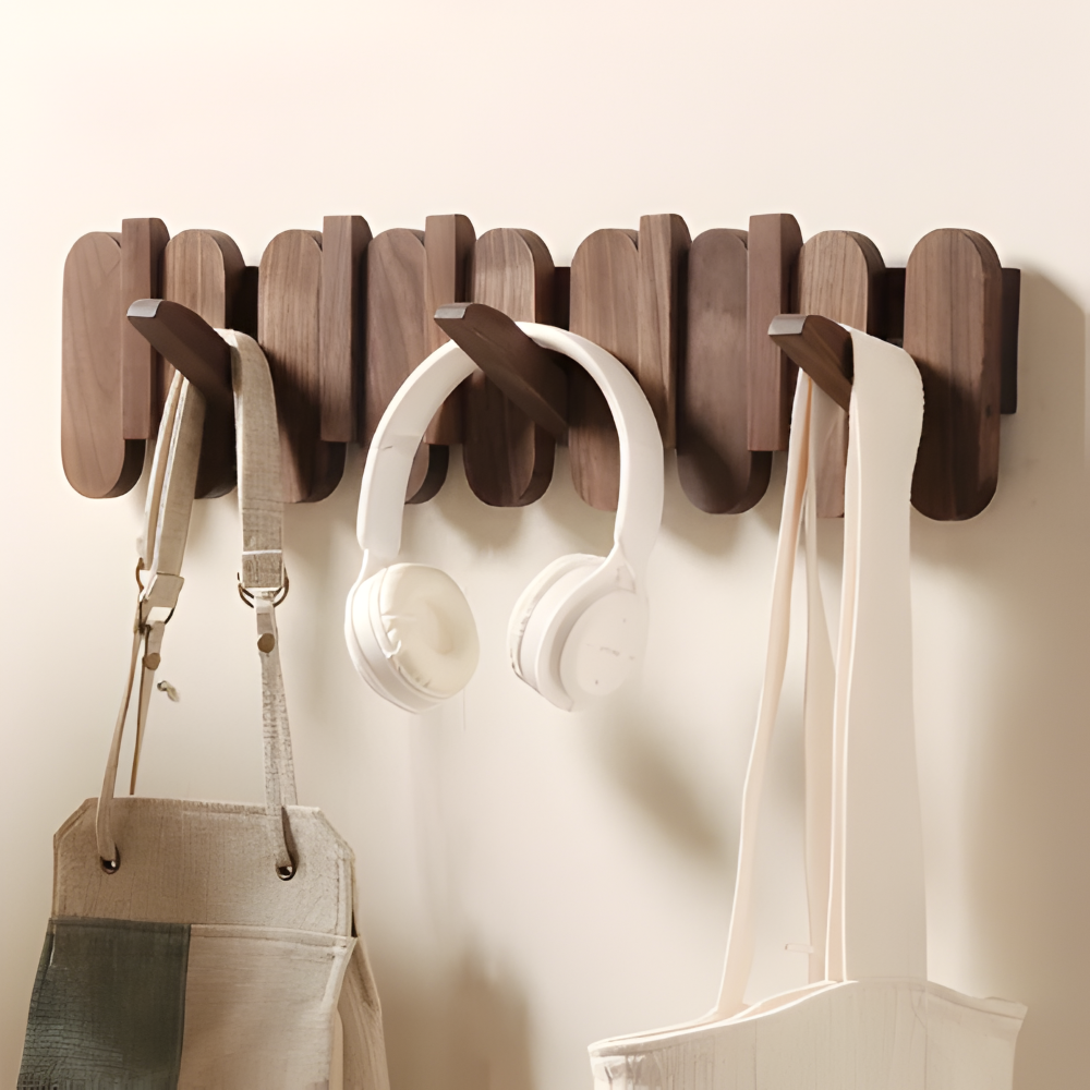 Walnut wood wall coat rack with rounded hooks mounted on hallway wall
