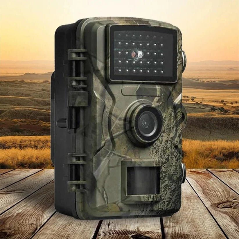 Trail camera with camouflage pattern mounted on tree in outdoor setting