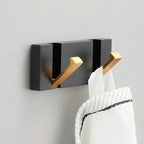 Foldable wall hook rail matte black gold hooks mounted on grey wall two white towels hanging bathroom setting