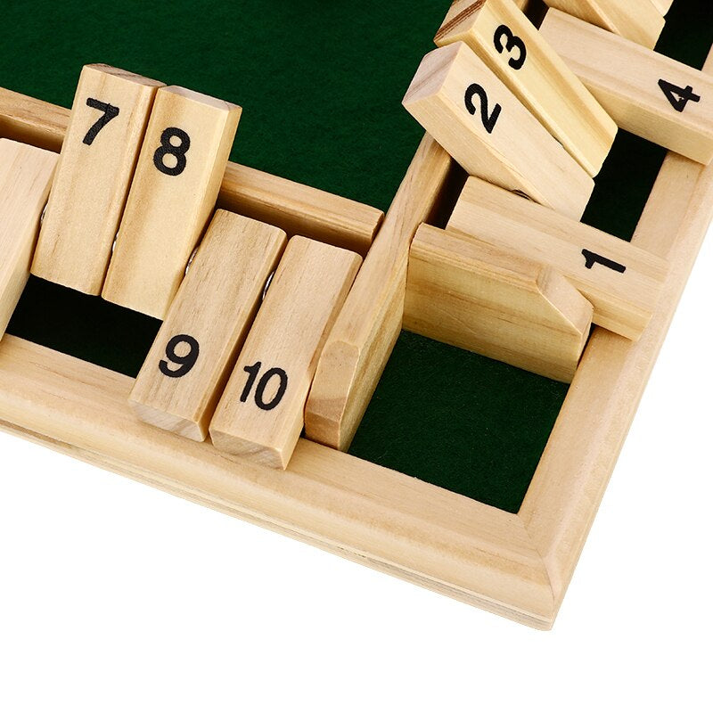 Shut the Box wooden dice board game 45-degree angle view with numbered tiles 1-10 and green felt playing surface on white background