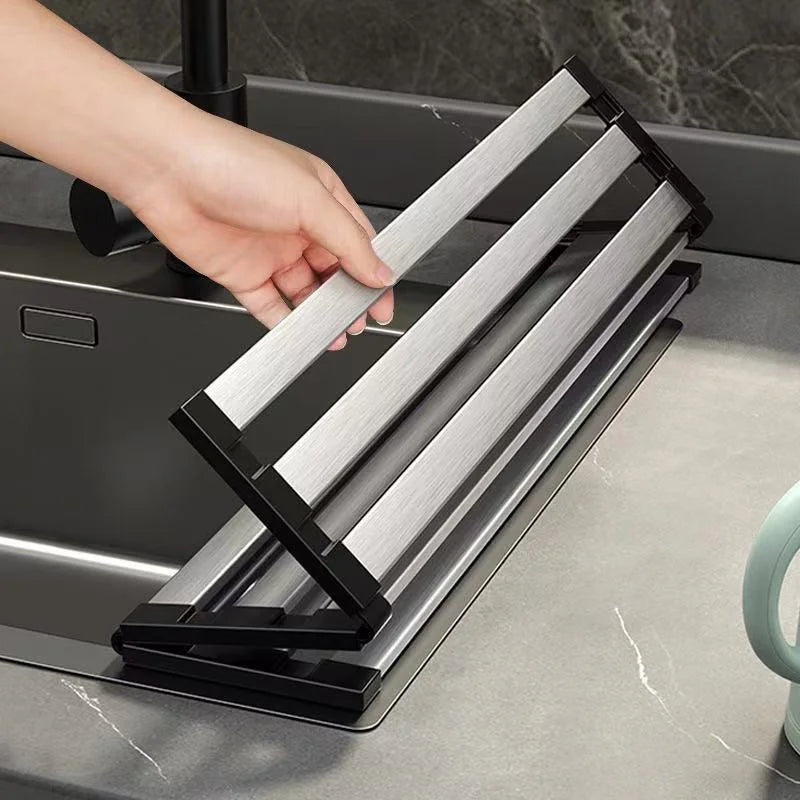Adjustable drain rack with slatted stainless steel base and rubber corner holders white background