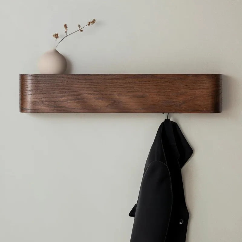 Walnut wood wall-mounted coat rack with display shelf on white studio background, front view