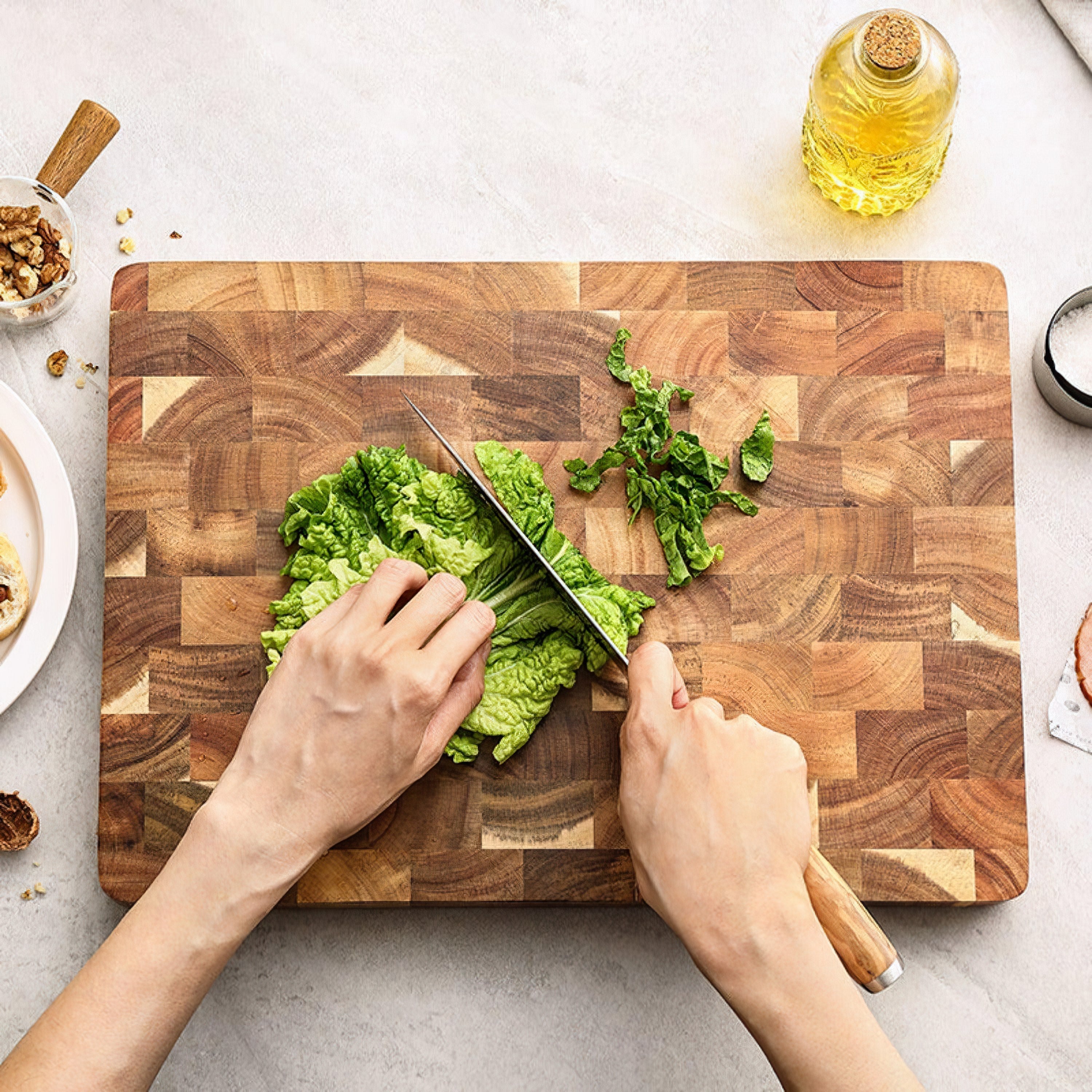 Professional cutting board solid acacia wood 34x24cm angled view showing grip detail white studio