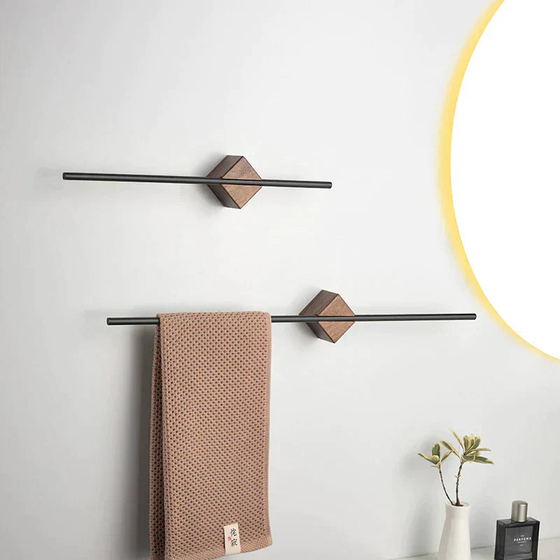 Single walnut wood towel bar with matte black bar on white background, front view showing diamond-shaped wooden bracket and slim bar profile