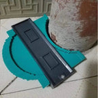 Hand holding contour gauge measuring irregular pipe shape in workshop setting