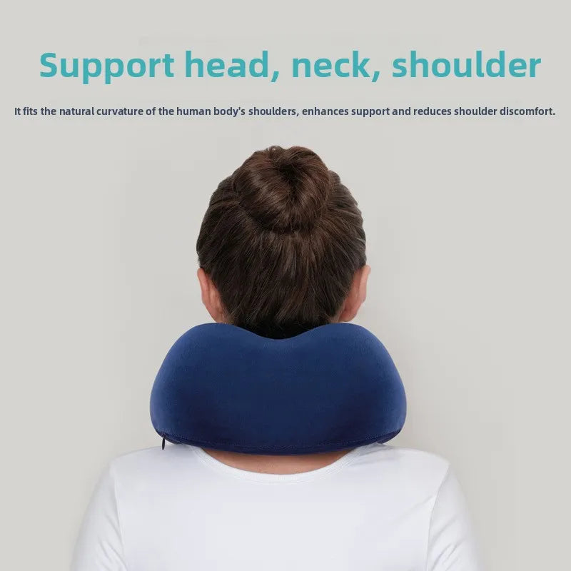 Navy blue U-shape memory foam neck pillow worn by a person showing head and shoulder support from behind