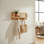 Wooden wall shelf with rattan panel and four wooden peg hooks on pure white background, studio shot front view