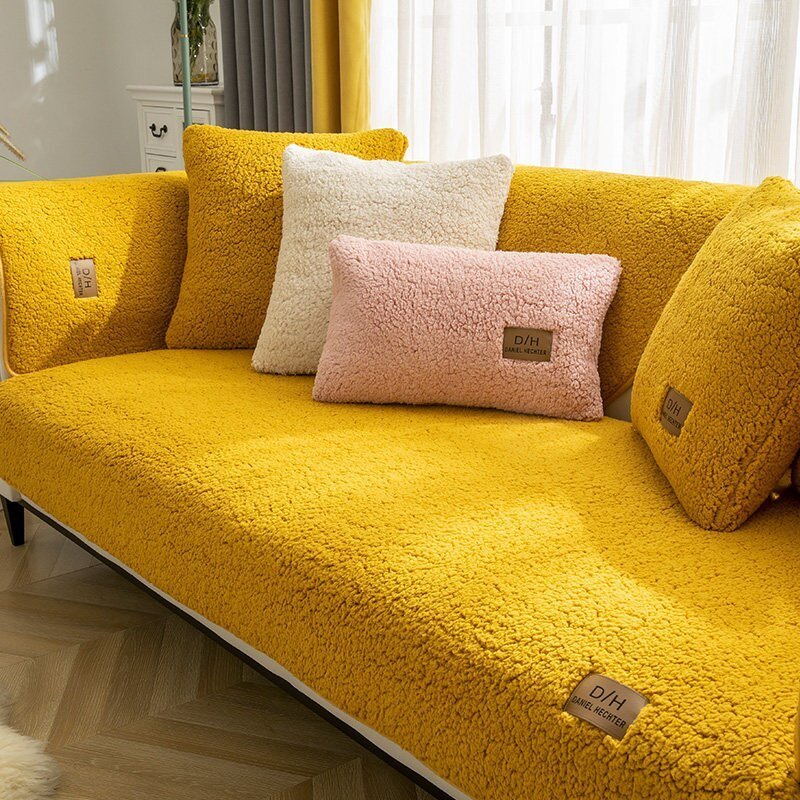 Studio product shot teddy fleece sofa cover folded showing soft polyester texture white background