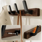 Walnut wood wall coat rack with 4 black hooks on white background, front view showing full board and hook detail