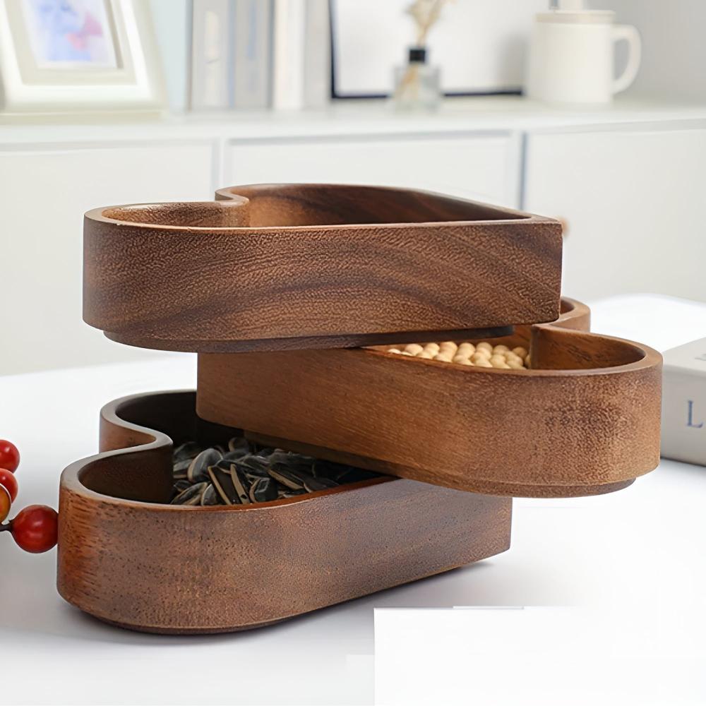 Set of four heart-shaped walnut wooden bowls on white background studio shot showing natural wood grain and smooth finish