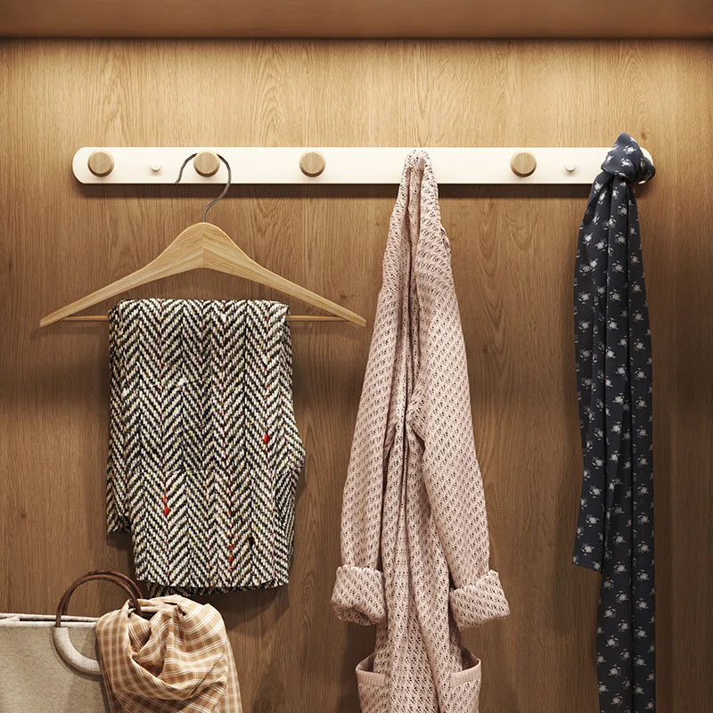 Single white wall coat rack with 6 rounded wooden hooks on clean white background, front view