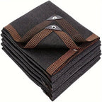 Dark brown rectangular shade sail folded on white background showing reinforced metal eyelet corners and striped binding tape
