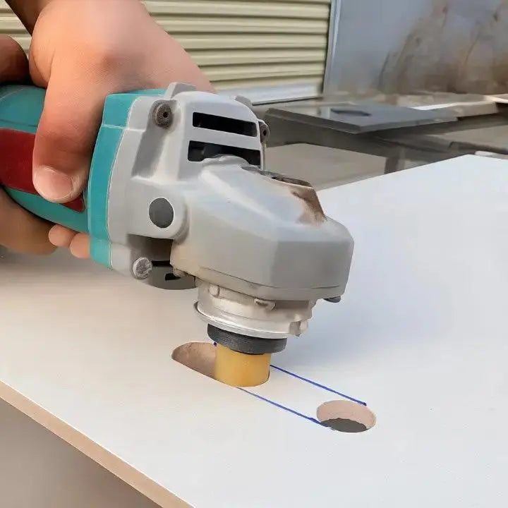 Diamond grinding disc mounted on angle grinder cutting curved edge in marble stone surface