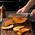 Large teak wood cutting board on modern kitchen bench with fresh vegetables and natural lighting