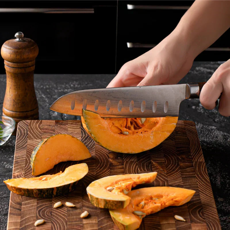 Large teak wood cutting board on modern kitchen bench with fresh vegetables and natural lighting