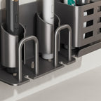 Close-up detail of self-adhesive mounting strip and integrated drainage holes in toothbrush holder