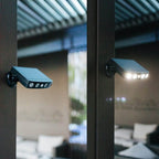 Garden pathway illuminated by multiple solar motion sensor lights creating security lighting