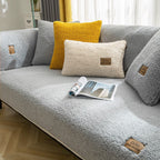 Yellow teddy fleece sofa cover on modern grey sofa with matching decorative cushions