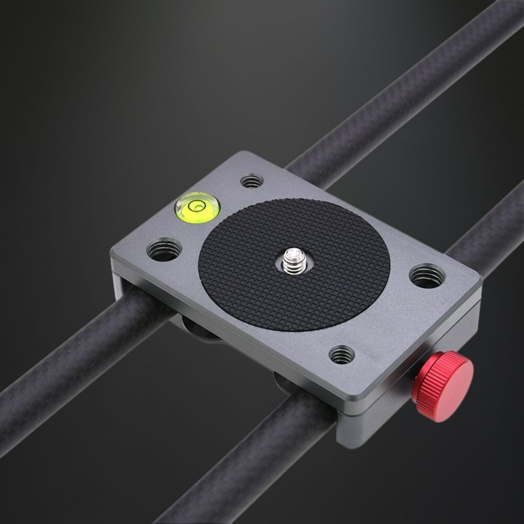 Photographer using camera slider rail outdoors for smooth tracking shot in lifestyle setting