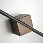 Two walnut wood towel bars angled view on grey wall with waffle-weave towel and small plant nearby, warm bathroom setting
