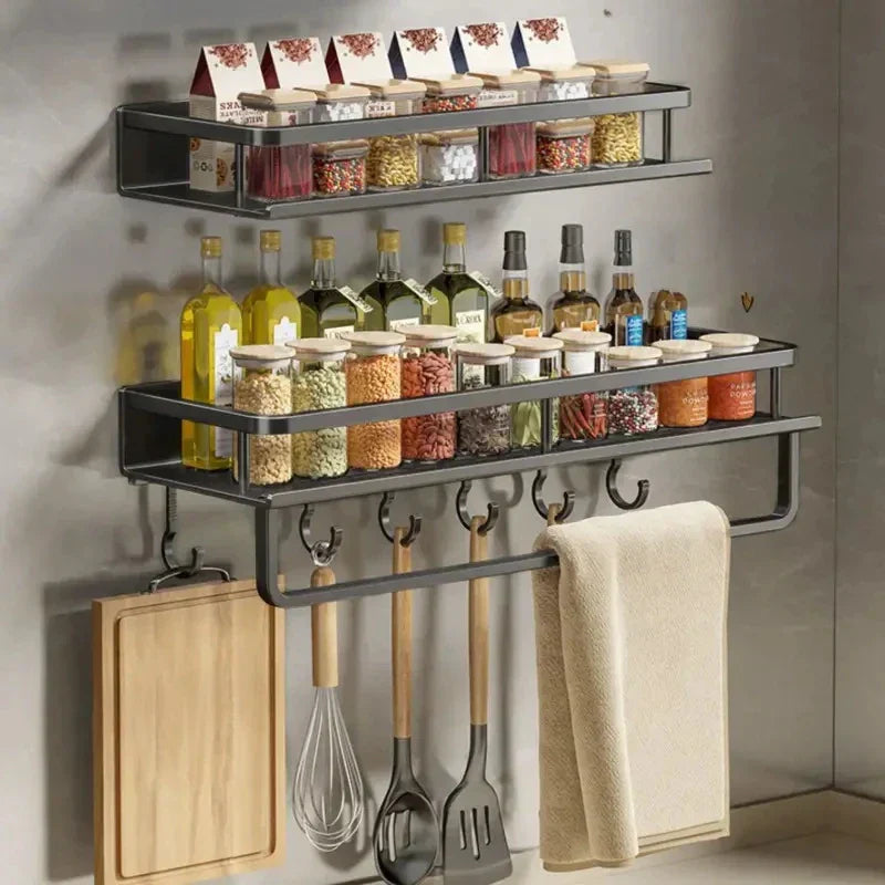 Wall-mounted kitchen storage shelf in modern kitchen with oils and cooking utensils organised