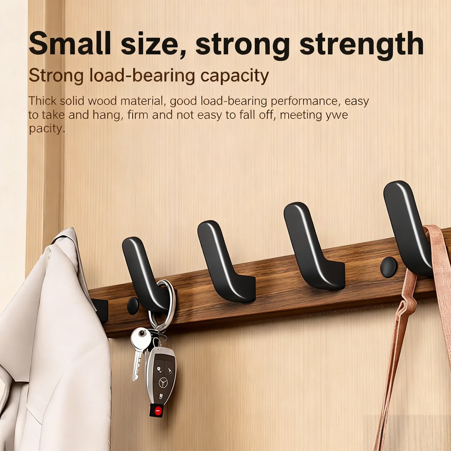 Close-up of walnut wood grain and single matte black metal hook on wall coat rack, warm lighting