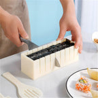 Cream sushi moulds on timber kitchen bench with finished sushi rolls displayed inside rectangular slicing mould