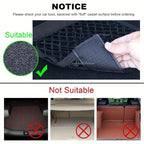 Car boot mesh net mounted between front seats holding water bottle and tablet in grey car interior