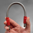 Close-up of flexible shaft bending around corner with screwdriver bit engaged in red quick-release connector
