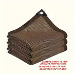 Garden patio with brown shade sail providing UV protection over outdoor dining table and chairs