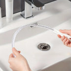 Close-up detail of spiral bristle head on flexible drain cleaning brush with hair debris caught on bristles